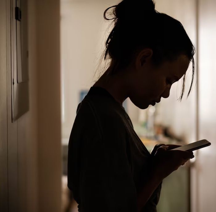 teenager looking at her phone