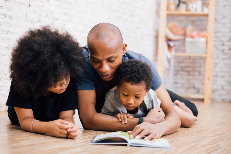 a father reading to two children a boy and a girl