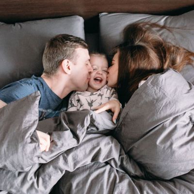 family in bed with their child